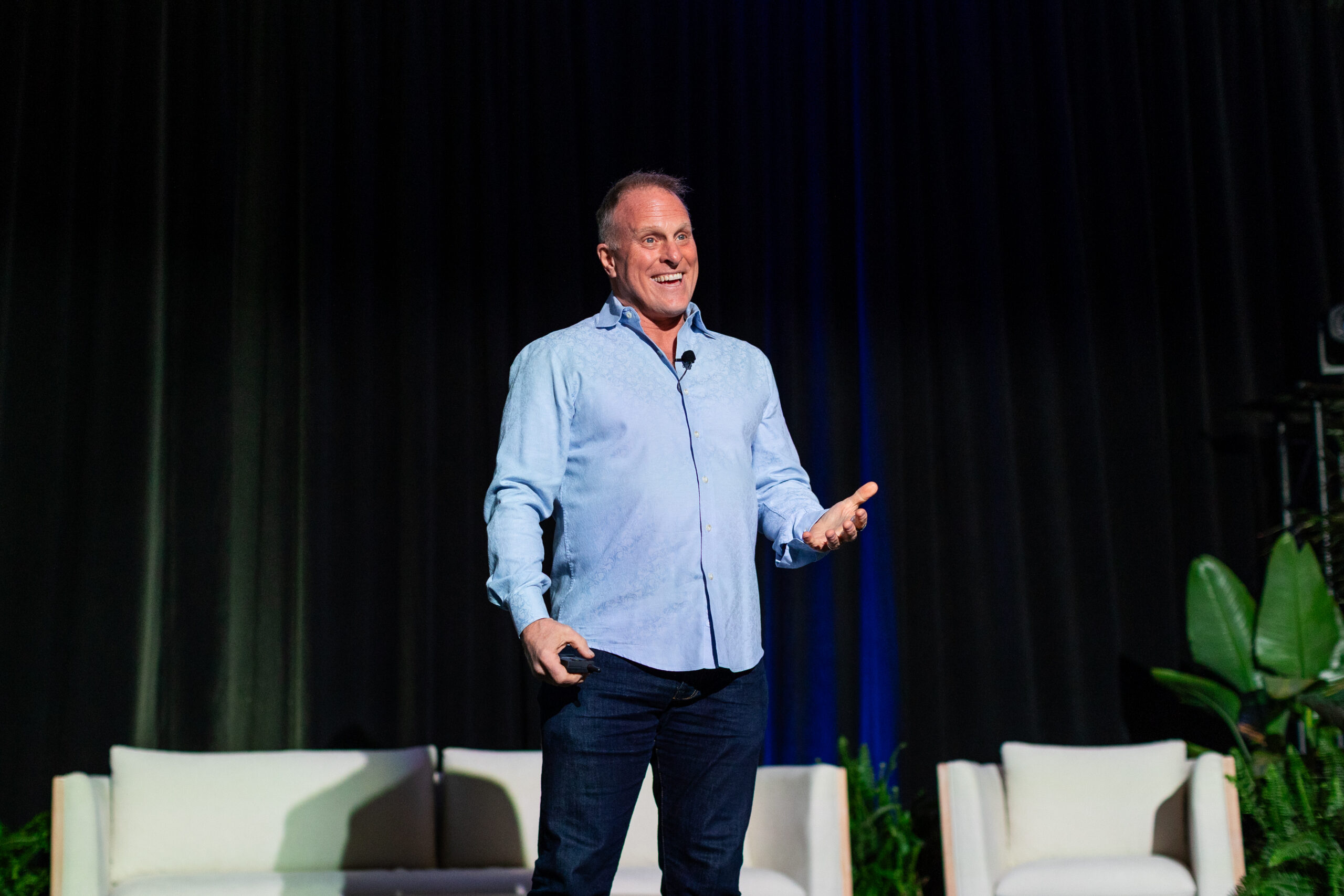John K. Bates smiling while delivering a keynote