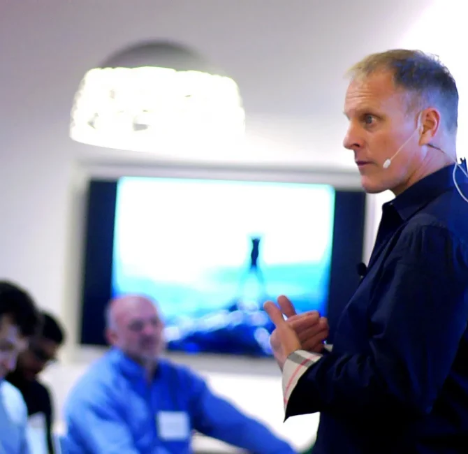 John Bates speaking with participants during a leadership communication workshop in Houston